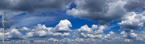 Blue sky with white and dark clouds. Panoramas photo.Stock photo