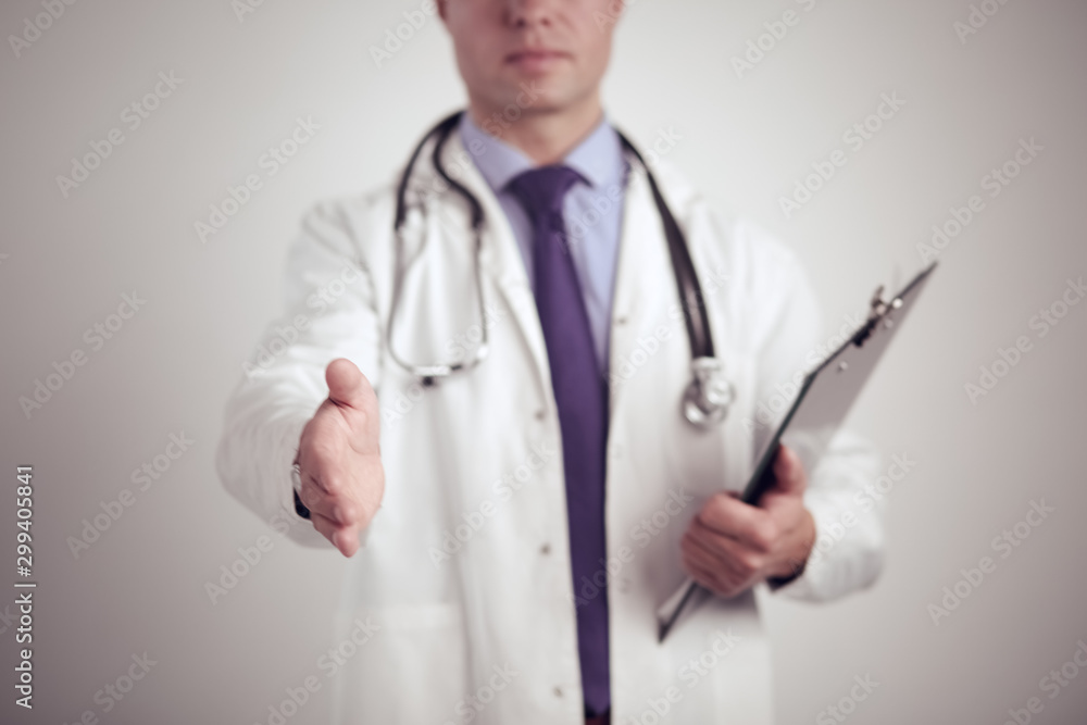 Friendly male doctor with open hand ready for hugging Friendly male doctor with open hand ready for hugging