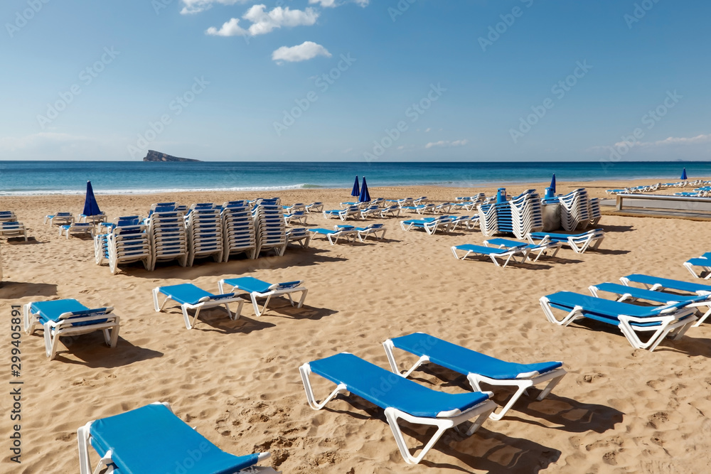 Blue Sunchairs on Beach in Benidorm Spain