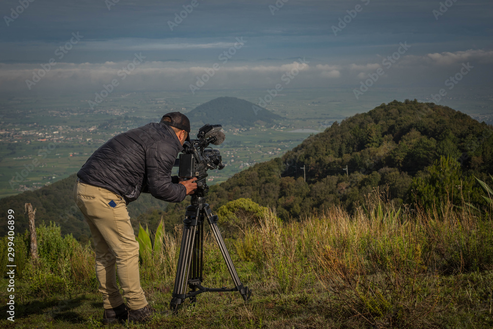 Man filming a landscape for a nature documentary to mexican landscape, Jiquipilco, Mexico 