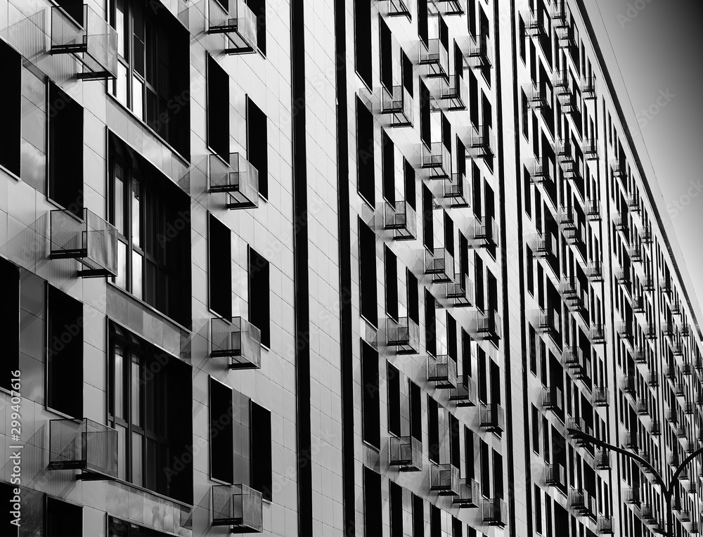 Fototapeta premium Minimalistic black and white building with multiple balconies