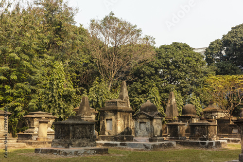 Kolkata, West Bengal/India - January 26 2018: The gothic, Indo-Saracenic tombs of the South Park Street Cemetery built in the 19th century, surrounded by trees.