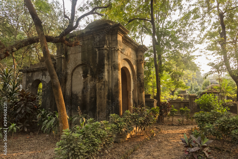 Kolkata, West Bengal/India - January 26 2018: A gothic, Indo-Saracenic tomb built in the 19th century surrounded by trees inside the South Park Street cemetery.