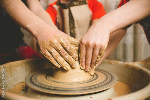 Children's hands make a mold of clay. Pottery