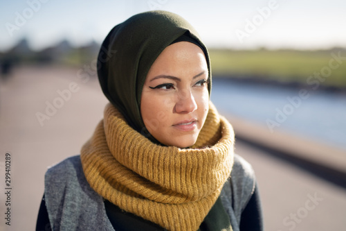 Portrait of a young woman wearing headscarf looking away