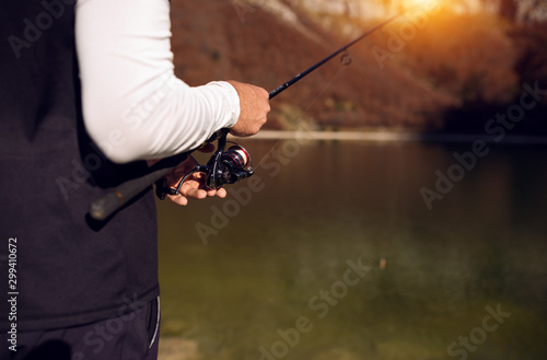Close up view of fisherman holding rod and fishing © Novak