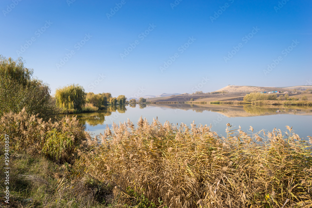 Beautiful landscape scenery of lakeshore and hills under a blue sky