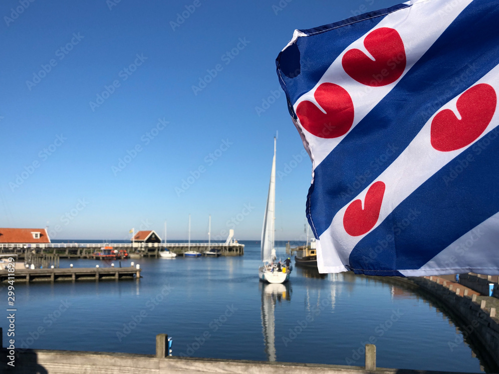 Frisian flag at the harbor in Hindeloopen