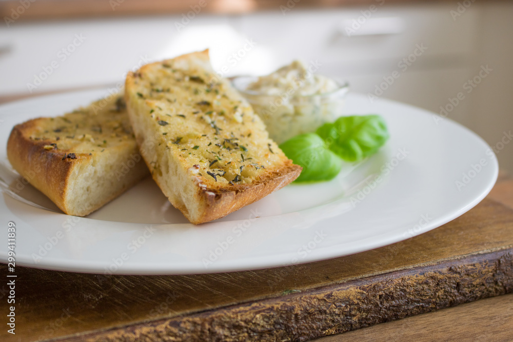 Food phtography of garlic bread with garlic butter on a white plate