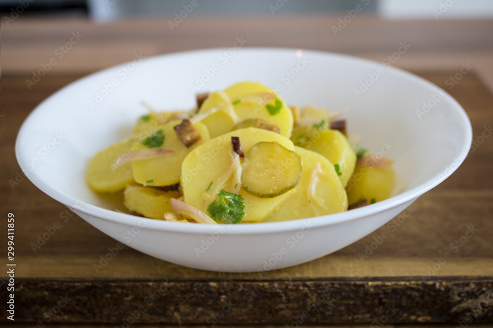 Food photography of a traditional German potato salad in a white bowl Food photography of a traditional German potato salad in a white bowl