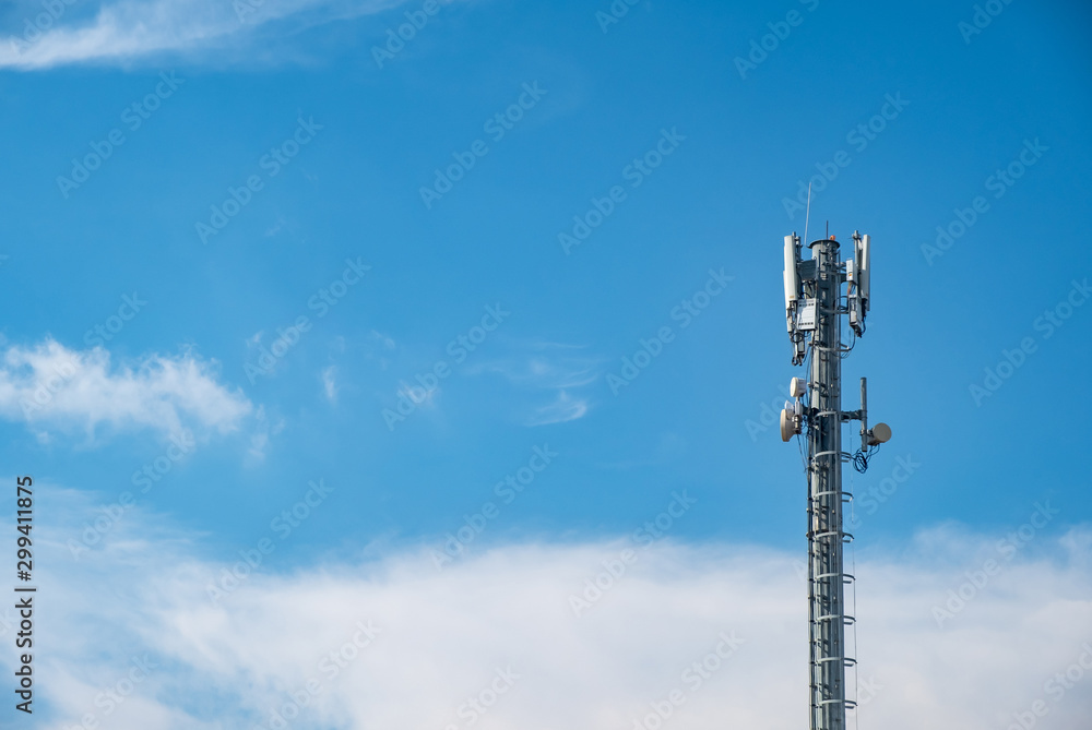 Cellular Base Station or Base Transceiver Station. Telecommunication tower. Wireless Communication Antenna Transmitter. 3G, 4G and 5G Cell Site with cloudy blue sky. Cellular Base Station or Base Transceiver Station. Telecommunication tower. Wireless Communication Antenna Transmitter. 3G, 4G and 5G Cell Site with cloudy blue sky.