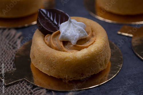 Cake shells filled with pumpkin spice cream, decorated  with chocolate leaves and little royal icing pumpkins photo