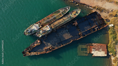 Aerial photo of shipwreck abandoned to rust in industrial bay of Elefsina, Attica, Greece