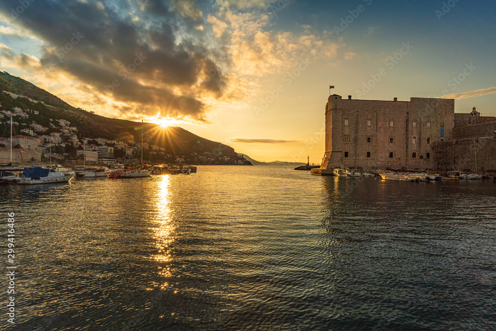 Beautiful wide angle view of sunrise over the old port in Dubrovnik, Croatia