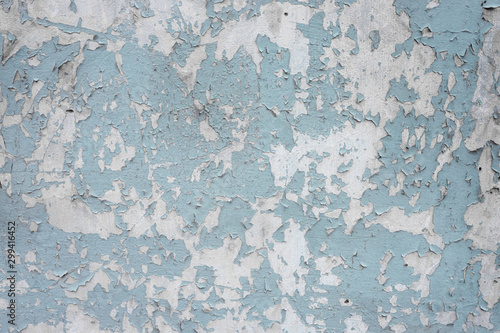 An old ragged blue plaster wall texture