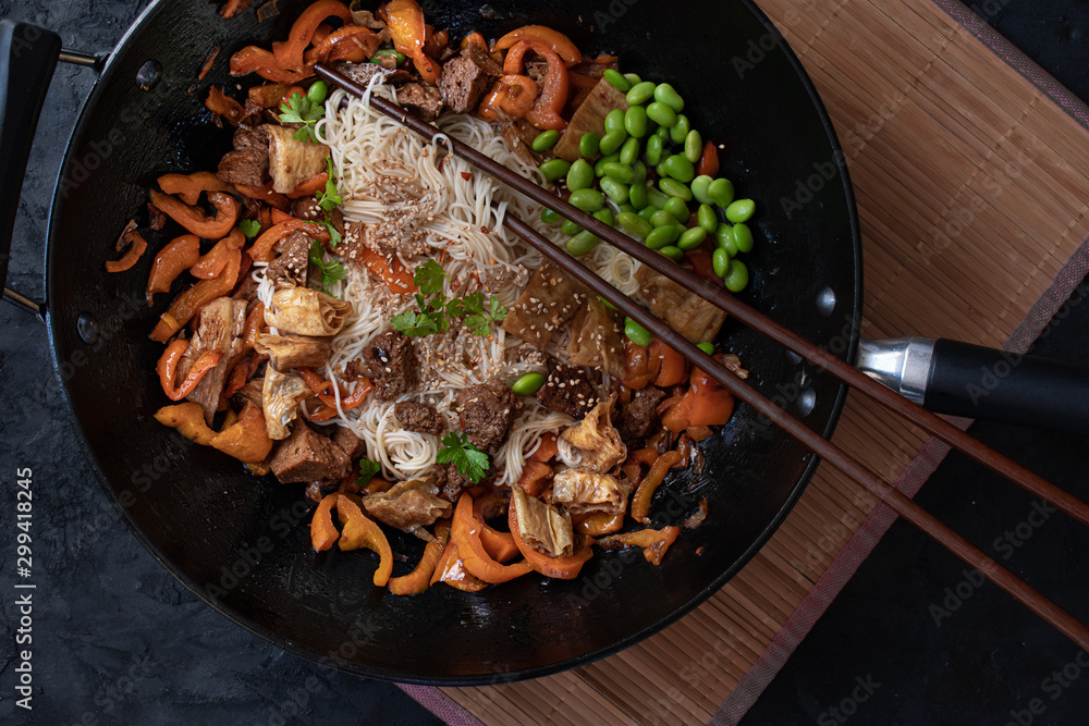 Vegan Stir Fry with yuba, seitan, bell pepper, edamame. .Wheat noodles