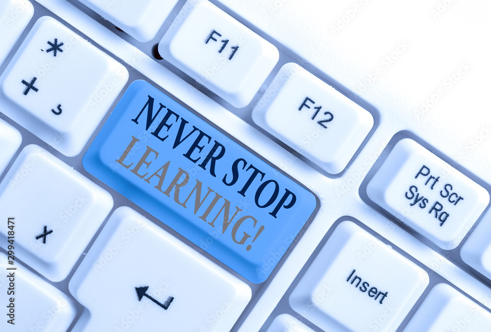 Handwriting text Never Stop Learning. Conceptual photo keep on studying gaining new knowledge or materials White pc keyboard with empty note paper above white background key copy space Handwriting text Never Stop Learning. Conceptual photo keep on studying gaining new knowledge or materials White pc keyboard with empty note paper above white background key copy space