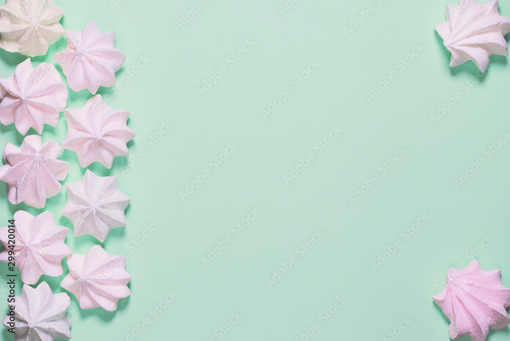 Small meringues on colorful background. Festive and party concept. Minimal style. Flat lay. Top view Small meringues on colorful background. Festive and party concept. Minimal style. Flat lay. Top view