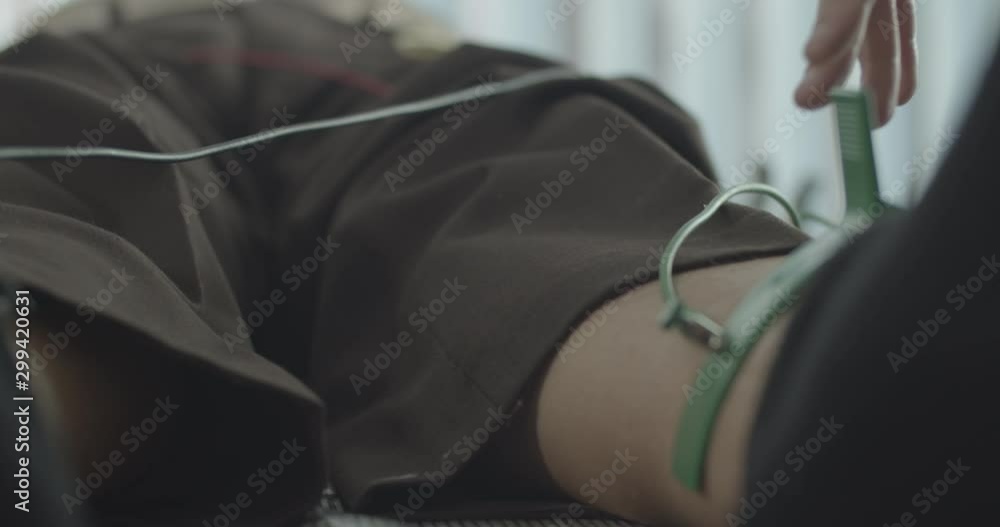 Medical technician preparing elderly male patient for ECG test. Medical technician preparing elderly male patient for ECG test.