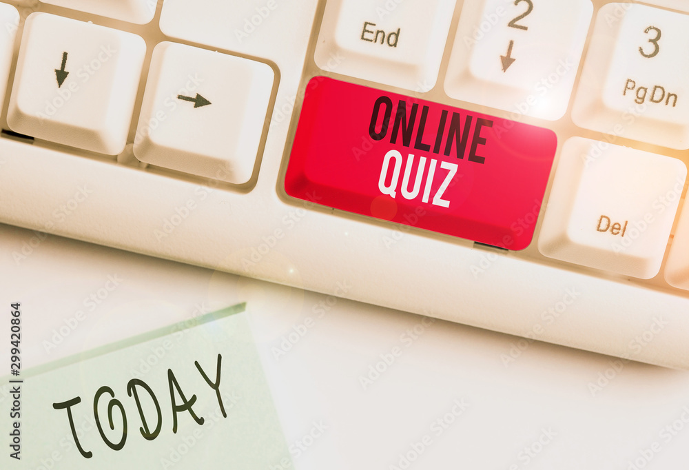 Conceptual hand writing showing Online Quiz. Concept meaning game or a mind sport that are published on the Internet White pc keyboard with note paper above the white background - obrazy, fototapety, plakaty 