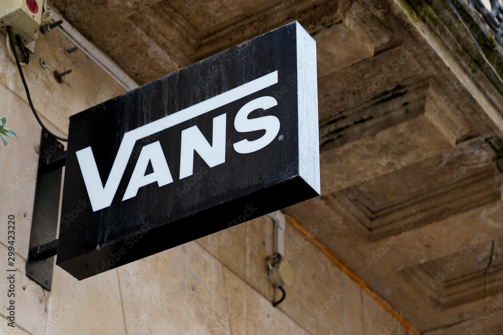 Vans shop sign logo store street american footwear shoes apparel company  specialized in skateboard Stock Photo | Adobe Stock
