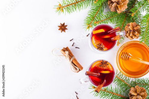 Mulled wine in glass mug with spices. Glasses of mulled wine with cinnamon, anise and fir tree branches. Winter Christmas drink. Top view. Flat lay