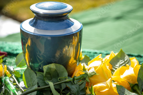 Urn with yellow roses, at an outdoor funeral photo