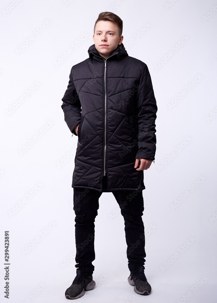 Fototapeta premium A man stand up wearing black jacket isolated white at the studio.