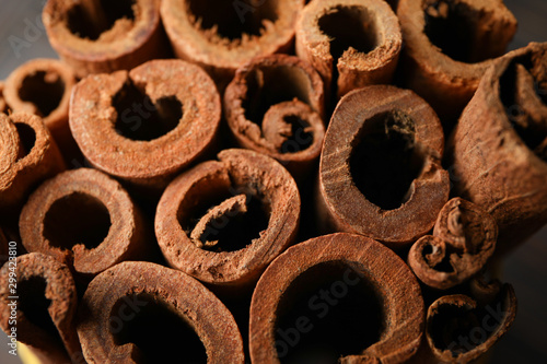Cinnamon sticks texture on whole background, space for text and close up