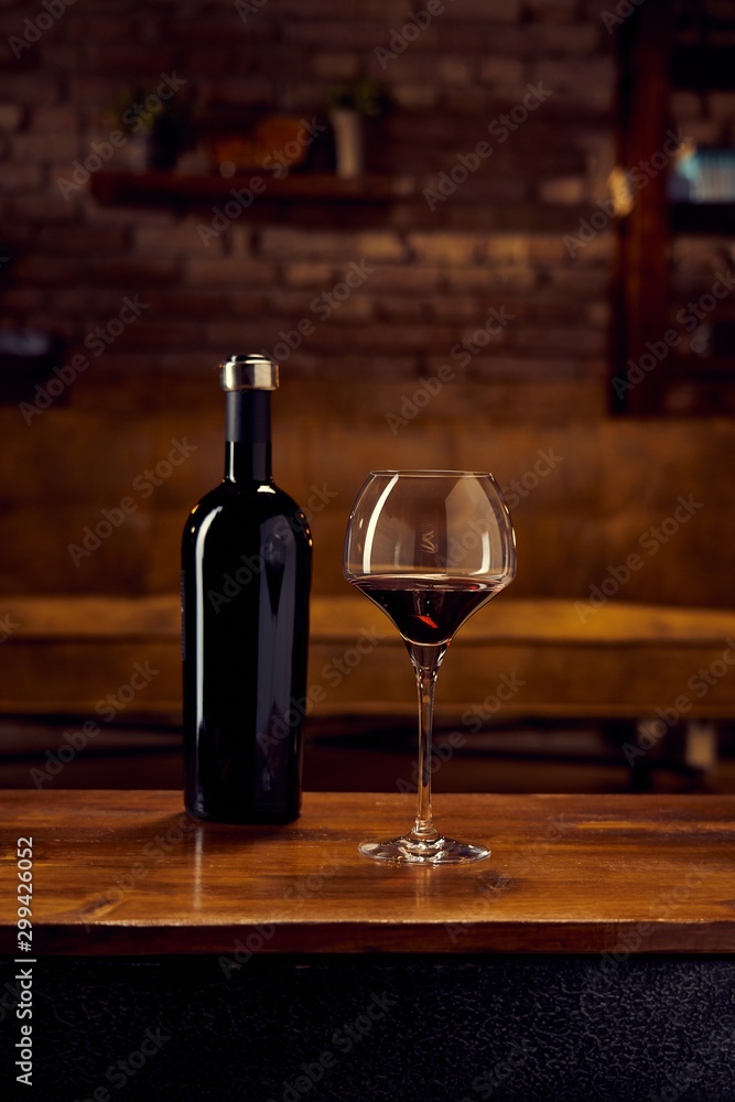 Glass of red wine on table at home
