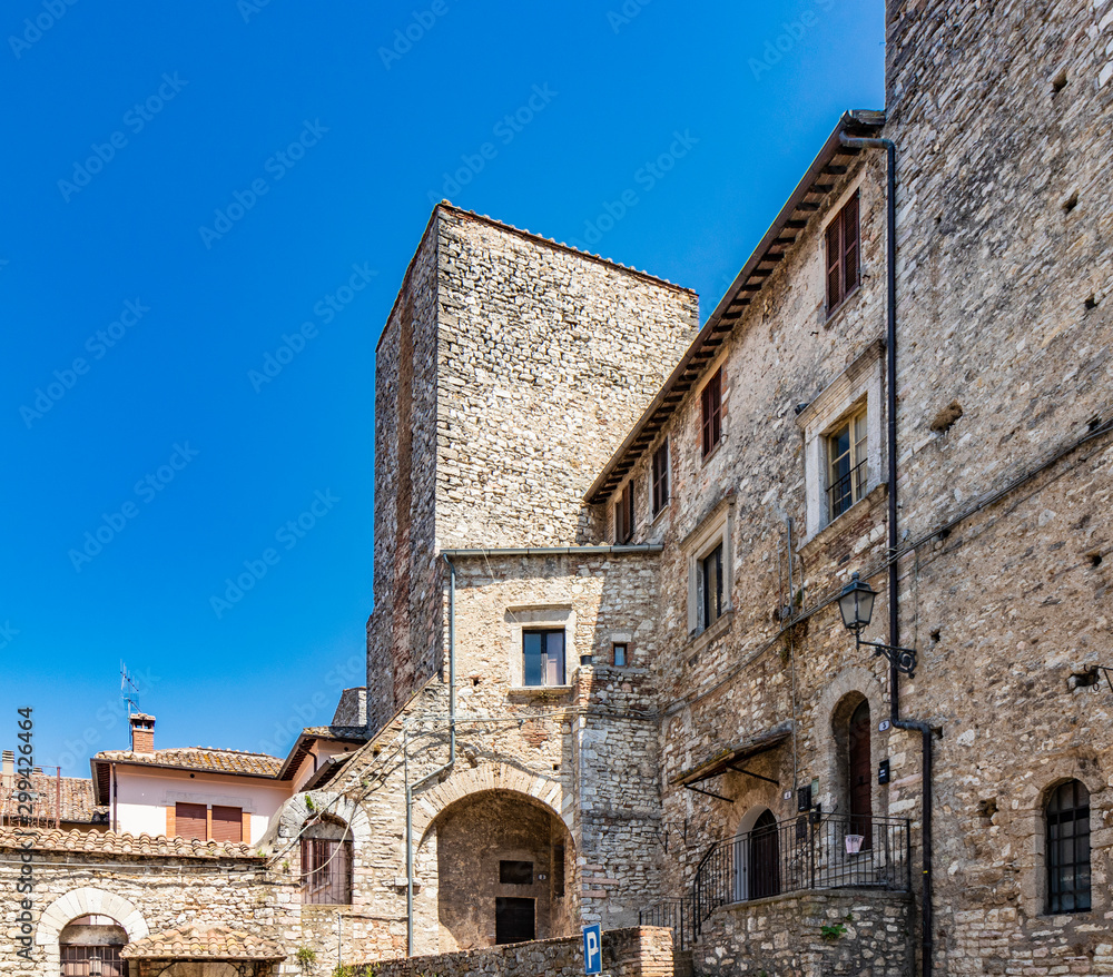 A characteristic glimpse in the ancient medieval village of Narni. Umbria, Terni, Italy. Old stone and brick buildings.The blue sky on a summer day. A tower.
