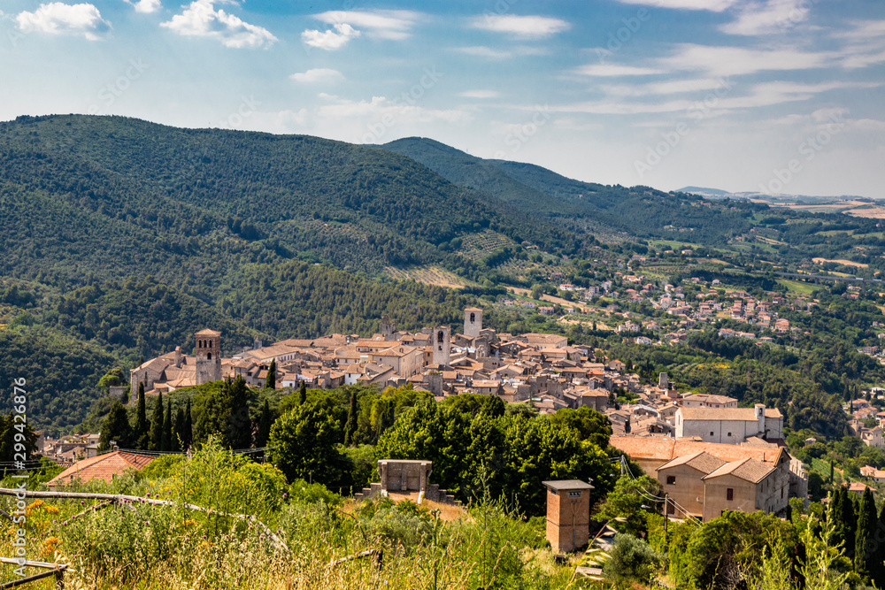 View from above of the ancient medieval village of Narni. Umbria, Terni, Italy. The view of the mountains, the trees, the nature. The red roofs of the houses, the bell towers of the churches.