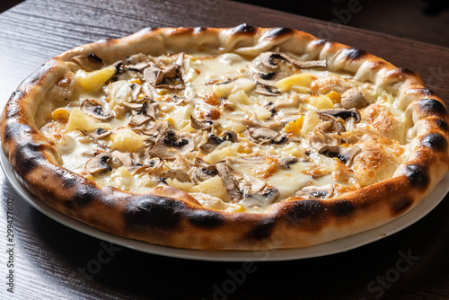 Cheap pizza with mushrooms, pineapple, and corn.