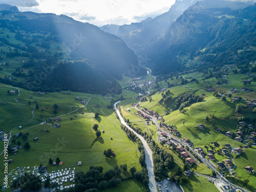 Sun shines over Swiss village Grindelwald after heavy storm in summer time near Swiss Alps photo