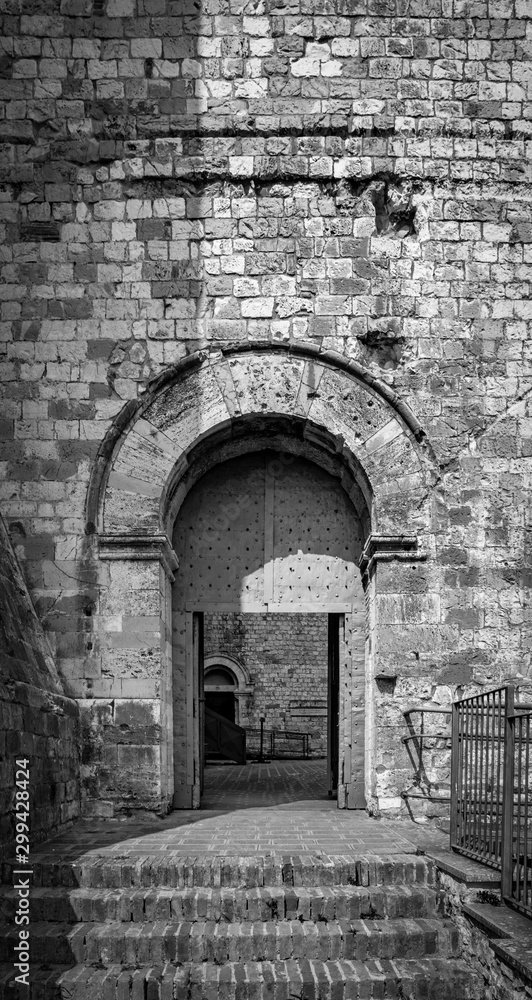The medieval castle of the ancient village of Narni. Umbria, Terni, Italy. The stone walls of the fortress. The entrance gate.