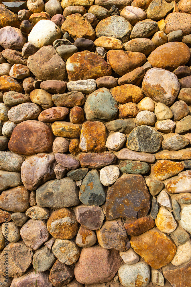 Textured stone wall bright multi-colored stones Textured stone wall bright multi-colored stones