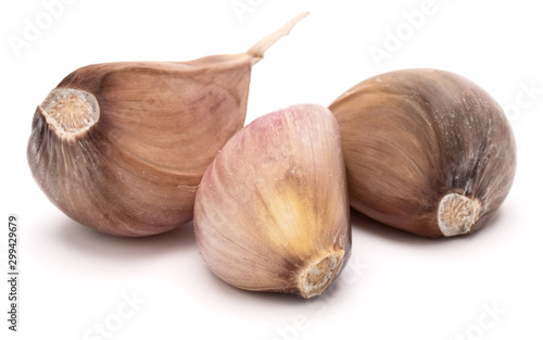 Three garlic cloves isolated on white background cutout
