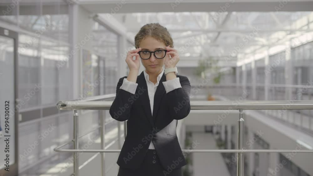 Business lady standing in office corridor Business lady standing in office corridor