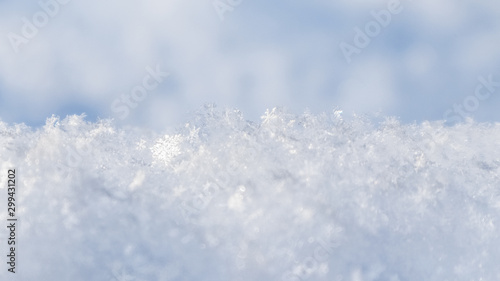 Background of fresh snow. Natural winter background. Snow texture in blue tone © OLAYOLA