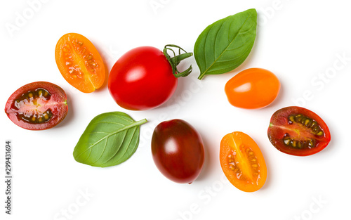 Fototapeta Naklejka Na Ścianę i Meble -  various colorful tomatoes and basil leaves isolated on white background. Top view, flat lay. Creative layout.