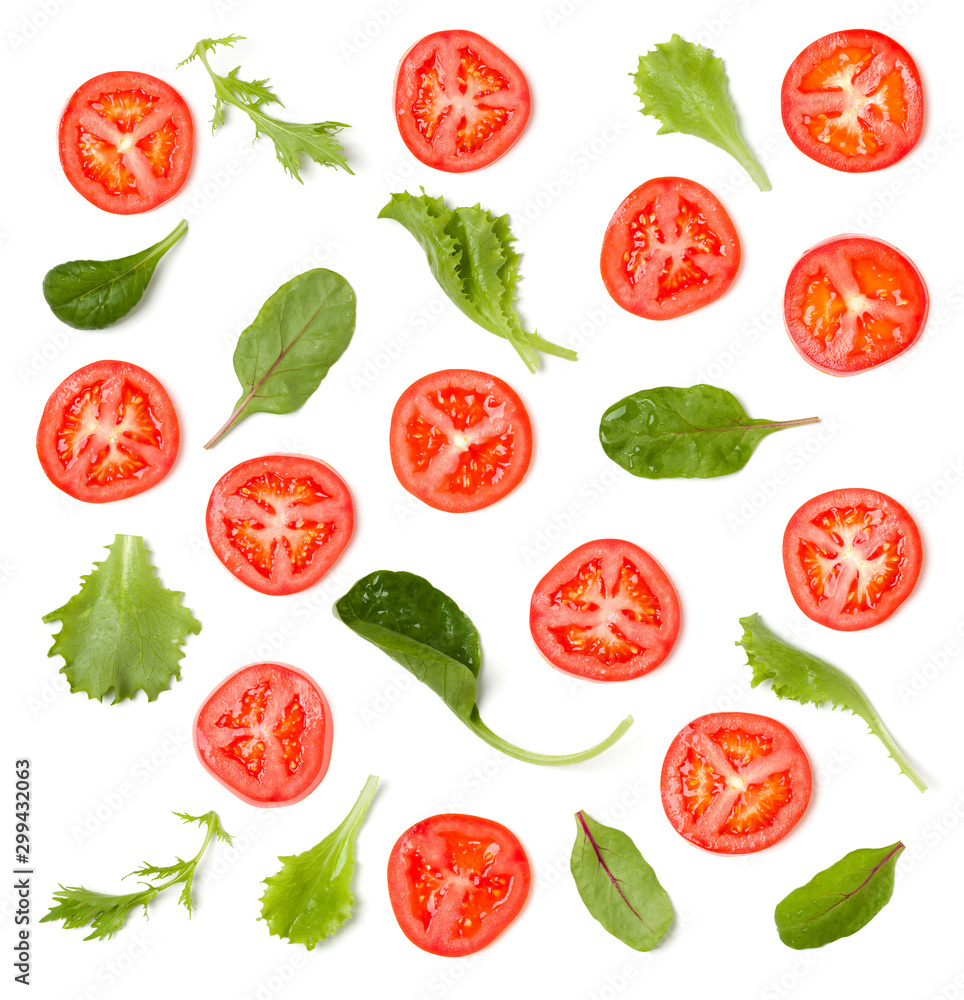 Creative layout made of tomato slices and salad leaves. Flat lay, top view. Vegetables isolated on white background. Food ingredient pattern. Creative layout made of tomato slices and salad leaves. Flat lay, top view. Vegetables isolated on white background. Food ingredient pattern.