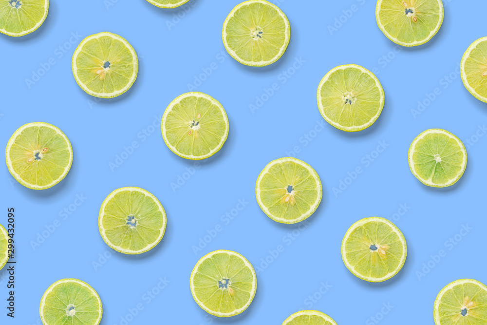 Fruit pattern of lemon slices on blue background. Flat lay, top view.