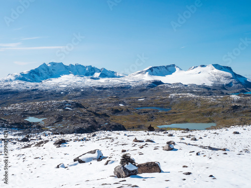Panoramic view from Krossbu on glacier Smorstabbreen, snow-capped mountains and blue lakes in Jotunheimen National Park, Western Norway photo