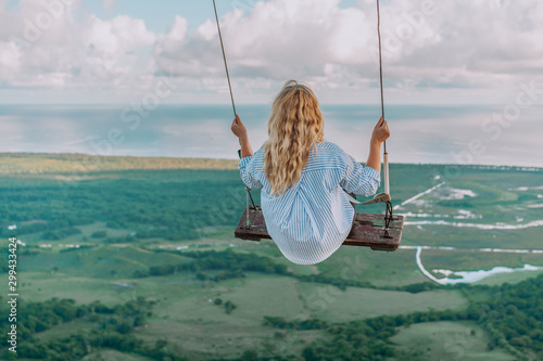 Beautiful view of young woman swing on the top of the mountain Redonda in Dominican Republic. Concept travel, vacation