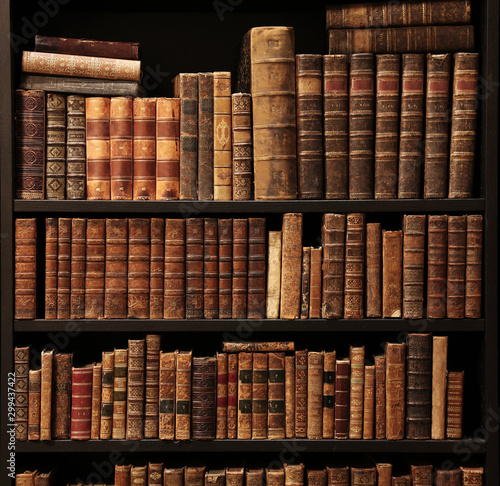 old books on wooden shelf. photo