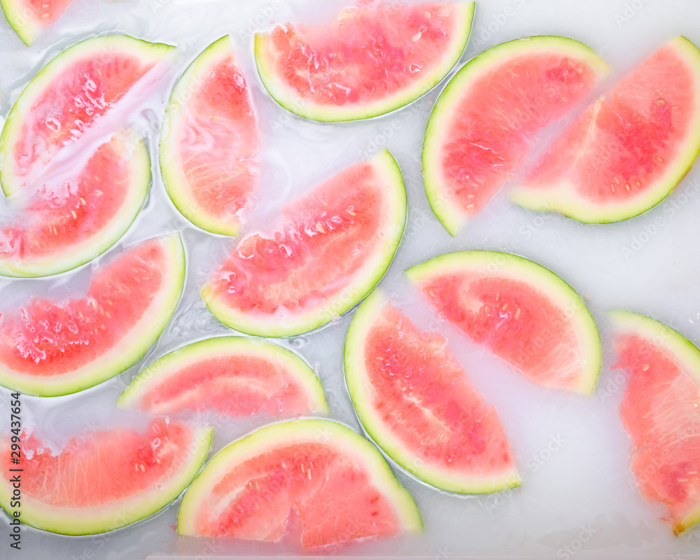 Turbid soapy water in bath with slices of watermelon. top view in full frame. The largest berry. spa with milk in the bath for rejuvenation.. Turbid soapy water in bath with slices of watermelon. top view in full frame. The largest berry. spa with milk in the bath for rejuvenation..