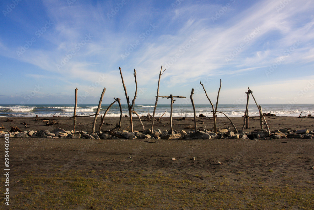 Wood sign on the Hokitika beach, Westcoast, New Zealand