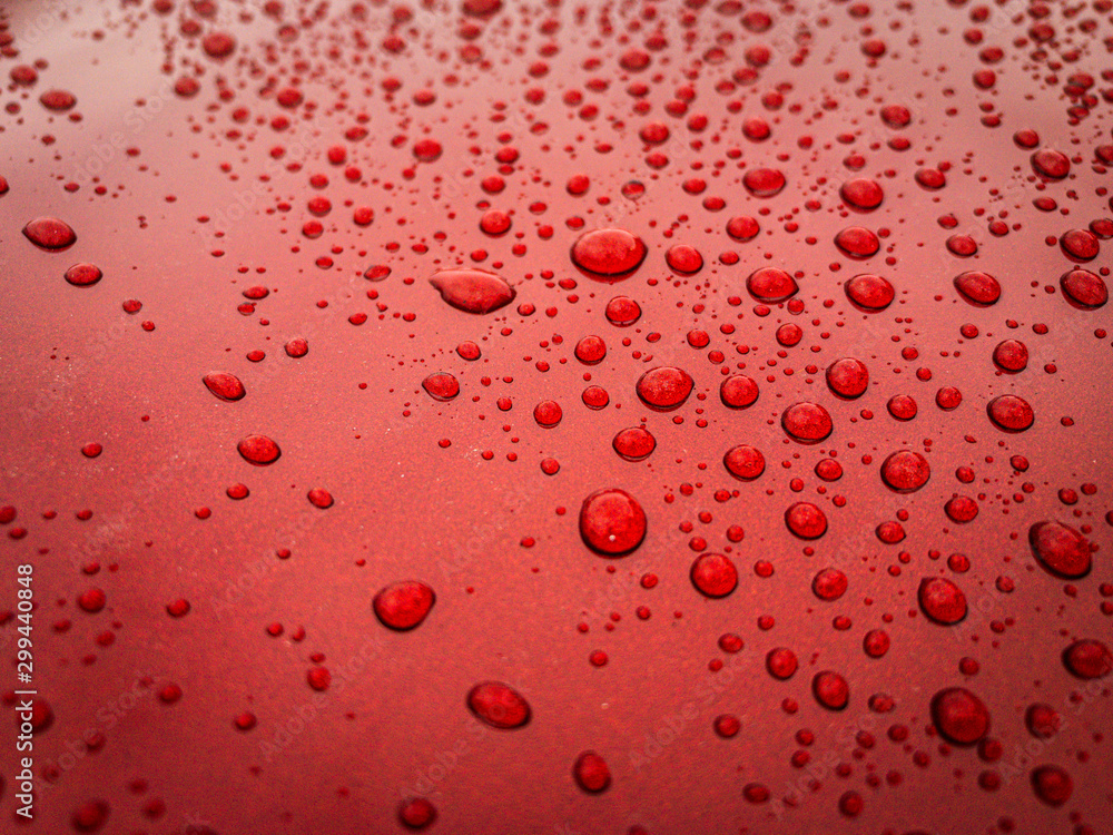 hood of red car, covered in raindrops hood of red car, covered in raindrops