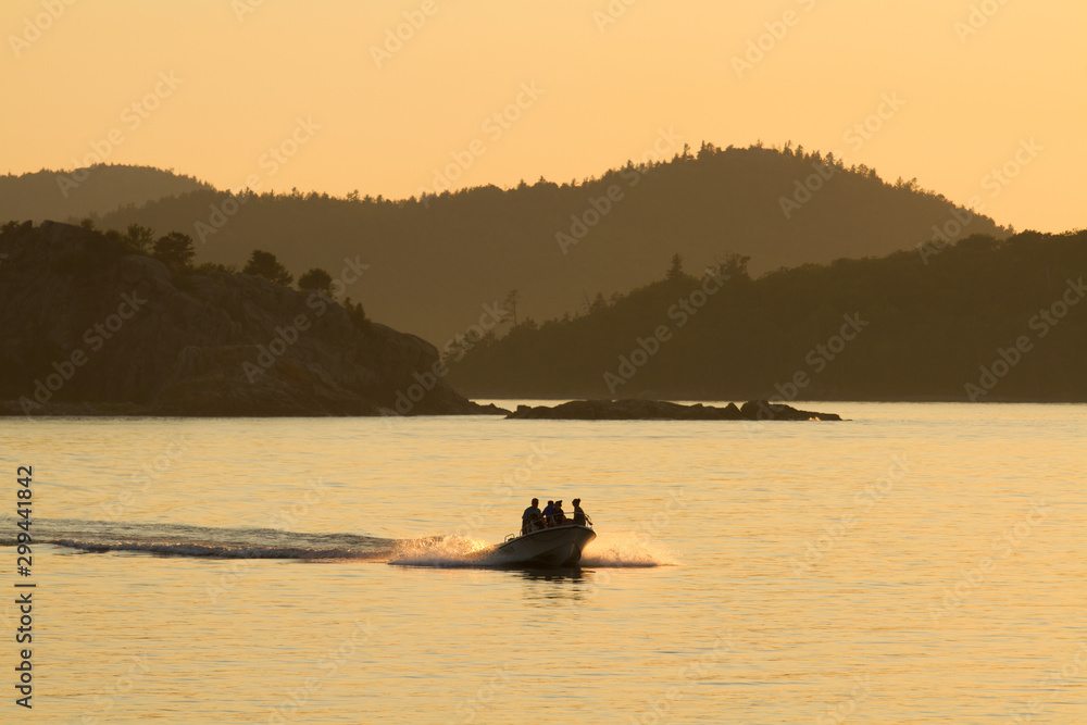A speedboat at sunset on Lake Superior