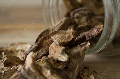 Close-up photography of dried porcini mushrooms and a glass jar